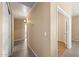 Hallway with neutral paint, and a mix of wood and tile flooring at 93 S Sandstone St, Gilbert, AZ 85296