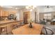 Eat-in kitchen with wood cabinetry, stainless appliances, and a breakfast bar with seating at 93 S Sandstone St, Gilbert, AZ 85296