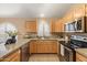 Updated kitchen boasts granite countertops, stainless steel appliances, ample storage, and a convenient layout for cooking at 93 S Sandstone St, Gilbert, AZ 85296