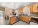 Charming kitchen featuring wooden cabinets, granite countertops, and arched shuttered windows at 93 S Sandstone St, Gilbert, AZ 85296