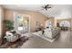 Bright living room features tiled floors, vaulted ceilings, stylish furniture, and sliding glass doors to the patio at 93 S Sandstone St, Gilbert, AZ 85296