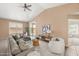 Cozy living room with vaulted ceilings, neutral decor, and sliding glass doors to the patio at 93 S Sandstone St, Gilbert, AZ 85296