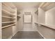 Spacious walk-in closet with built-in shelving and rods for optimal storage solutions at 93 S Sandstone St, Gilbert, AZ 85296