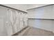 Spacious walk-in closet with white robes hanging, and shelving with rods for organized storage at 9735 W Catalina Dr, Phoenix, AZ 85037