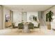 Contemporary dining area with seating for six, decorative lighting, and open floor plan at 9739 W Catalina Dr, Phoenix, AZ 85037