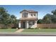Inviting two-story home with a red tile roof, neutral stucco, manicured lawn, and charming curb appeal at 9739 W Catalina Dr, Phoenix, AZ 85037