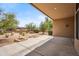 Inviting covered back patio overlooking professionally landscaped desert yard with mountain views at 1029 E Ian Dr, Phoenix, AZ 85042