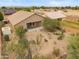 Aerial view of desert landscaped backyard with covered patio and block fence at 1029 E Ian Dr, Phoenix, AZ 85042
