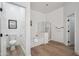 Bright bathroom featuring a separate shower, tub, and toilet area all with modern fixtures and finishes at 1029 E Ian Dr, Phoenix, AZ 85042
