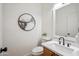 Bathroom with a stylish sink, toilet, and modern mirror, enhancing the space's appeal at 1029 E Ian Dr, Phoenix, AZ 85042