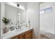 Stylish bathroom with a wood vanity, modern sink, and elegant mirror, offering a luxurious feel at 1029 E Ian Dr, Phoenix, AZ 85042
