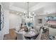 Bright dining area with chandelier, table set for six, and view into living area at 1029 E Ian Dr, Phoenix, AZ 85042