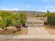Beautiful home with desert landscaping, a three-car garage, and mature trees in the front yard at 1029 E Ian Dr, Phoenix, AZ 85042