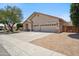 Attractive single-story home with a three-car garage, desert landscaping, and a paved driveway at 1029 E Ian Dr, Phoenix, AZ 85042
