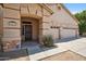 Close-up of the home's entrance featuring a porch, security system sign, and desert landscaping at 1029 E Ian Dr, Phoenix, AZ 85042