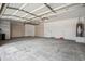 Spacious three car garage featuring overhead storage, a water heater and built-in storage cabinets at 1029 E Ian Dr, Phoenix, AZ 85042