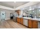 Open kitchen area with wood cabinets, stainless steel appliances, and modern design at 1029 E Ian Dr, Phoenix, AZ 85042
