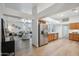 Open concept living room and kitchen with stainless steel appliances and wood floors at 1029 E Ian Dr, Phoenix, AZ 85042