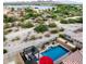 Aerial view showcases pool, covered patio, desert landscaping and lake views at 10507 S 181St Ave, Goodyear, AZ 85338