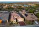Aerial view of a home with a tile roof and solar panels, set in a community with lake and mountain views at 10507 S 181St Ave, Goodyear, AZ 85338