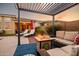 Relaxing backyard with cozy seating, outdoor fireplace, and lounge chairs at 10507 S 181St Ave, Goodyear, AZ 85338