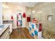 A bright primary bathroom featuring dual vanities, walk-in closet, and a large shower with tile walls and flooring at 10507 S 181St Ave, Goodyear, AZ 85338