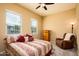 Serene bedroom featuring neutral tones, soft carpet, and two bright windows for natural light at 10507 S 181St Ave, Goodyear, AZ 85338