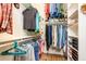 Well-organized walk-in closet with custom shelving and hanging rods for efficient storage solutions at 10507 S 181St Ave, Goodyear, AZ 85338