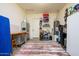 Neat garage with workbench, storage cabinets, shelving, and water heater for organized utility and projects at 10507 S 181St Ave, Goodyear, AZ 85338