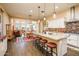 Open-concept kitchen with a large island, pendant lights, and stainless steel appliances at 10507 S 181St Ave, Goodyear, AZ 85338