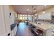 Beautiful open kitchen with granite countertops, wooden floors, island with barstool seating and stainless steel appliances at 10507 S 181St Ave, Goodyear, AZ 85338
