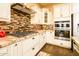 Modern kitchen with stainless appliances, granite counters, and stylish backsplash at 10507 S 181St Ave, Goodyear, AZ 85338