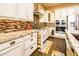 Modern kitchen boasts granite counters, stainless appliances, and custom cabinets with wood flooring at 10507 S 181St Ave, Goodyear, AZ 85338