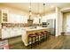 Spacious kitchen features granite countertops, stainless appliances, island with seating, and stylish backsplash at 10507 S 181St Ave, Goodyear, AZ 85338