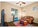 Cozy living room featuring modern tile flooring, comfortable sofa, and bright windows for natural light at 10507 S 181St Ave, Goodyear, AZ 85338