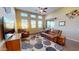 Comfortable living room featuring high ceilings, recessed lighting, decorative fixtures, and a large decorative carpet at 10507 S 181St Ave, Goodyear, AZ 85338