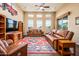 Cozy living room featuring a colorful rug, ceiling fan, and sliding glass door at 10507 S 181St Ave, Goodyear, AZ 85338