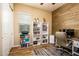 Office space with wood accent wall and built in white bookshelves at 10507 S 181St Ave, Goodyear, AZ 85338