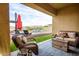 Comfortable outdoor living with a wicker sofa, gas fire pit, and chairs offering views of the private backyard pool at 10507 S 181St Ave, Goodyear, AZ 85338