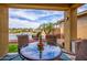 Charming outdoor patio with seating, a view of the private pool, and a lush backyard landscape at 10507 S 181St Ave, Goodyear, AZ 85338