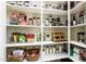 Organized pantry with multiple shelves and containers to neatly store food items and kitchen appliances at 10507 S 181St Ave, Goodyear, AZ 85338