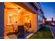 Outdoor patio with comfortable seating, ceiling fan, and landscaped yard for relaxing evenings at 10507 S 181St Ave, Goodyear, AZ 85338