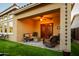 Covered outdoor patio with lounge seating and backyard access, perfect for relaxing and entertaining at 10507 S 181St Ave, Goodyear, AZ 85338