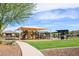Community playground featuring slides, climbing structures, a sun shade, and picnic areas for outdoor fun at 10507 S 181St Ave, Goodyear, AZ 85338