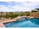Stunning swimming pool with a tile waterfall feature, surrounded by landscaping at 10507 S 181St Ave, Goodyear, AZ 85338
