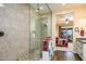 An elegant primary shower showcases glass enclosure, tiled walls, and convenient access to the adjacent bedroom at 10507 S 181St Ave, Goodyear, AZ 85338