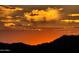 Beautiful desert sunset over a mountain range with vibrant orange and golden colors at 10507 S 181St Ave, Goodyear, AZ 85338