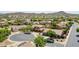 Aerial neighborhood view showcasing well-maintained homes with mature trees and mountain views at 11150 S Star Ct, Goodyear, AZ 85338