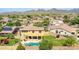An aerial view reveals the backyard with a pool, firepit, covered patio, and desert landscaping at 11150 S Star Ct, Goodyear, AZ 85338