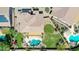 Aerial view of backyard featuring a pool, spa, fire pit, covered patio, and meticulously kept landscaping at 11150 S Star Ct, Goodyear, AZ 85338